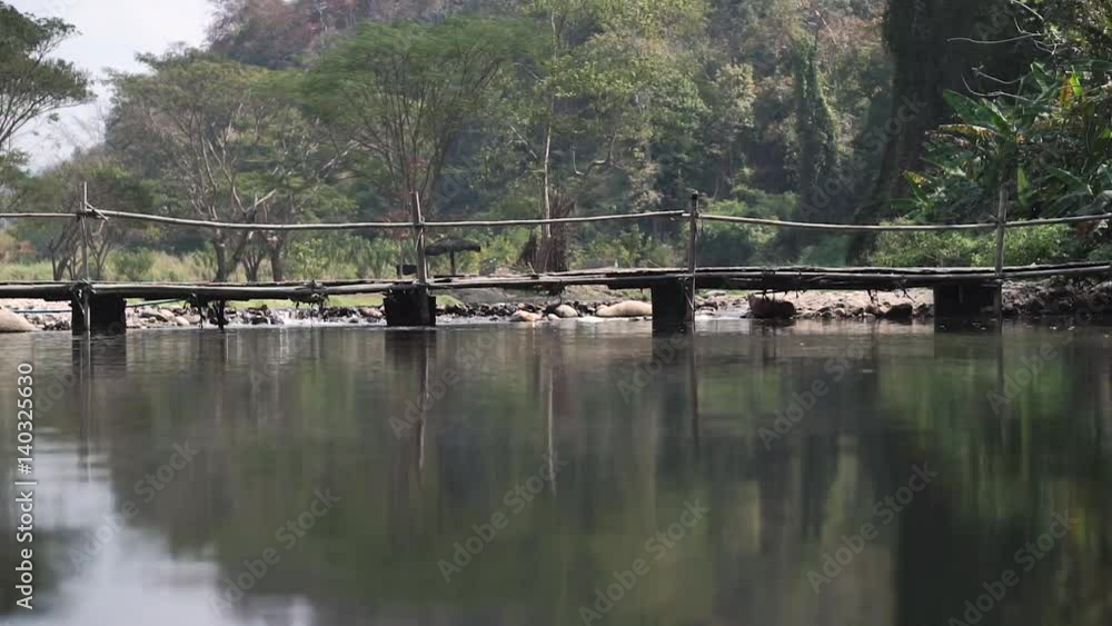 bamboo bridge over the river in the national park of an Asian country bamboo bridge over the river in the national park of an Asian country