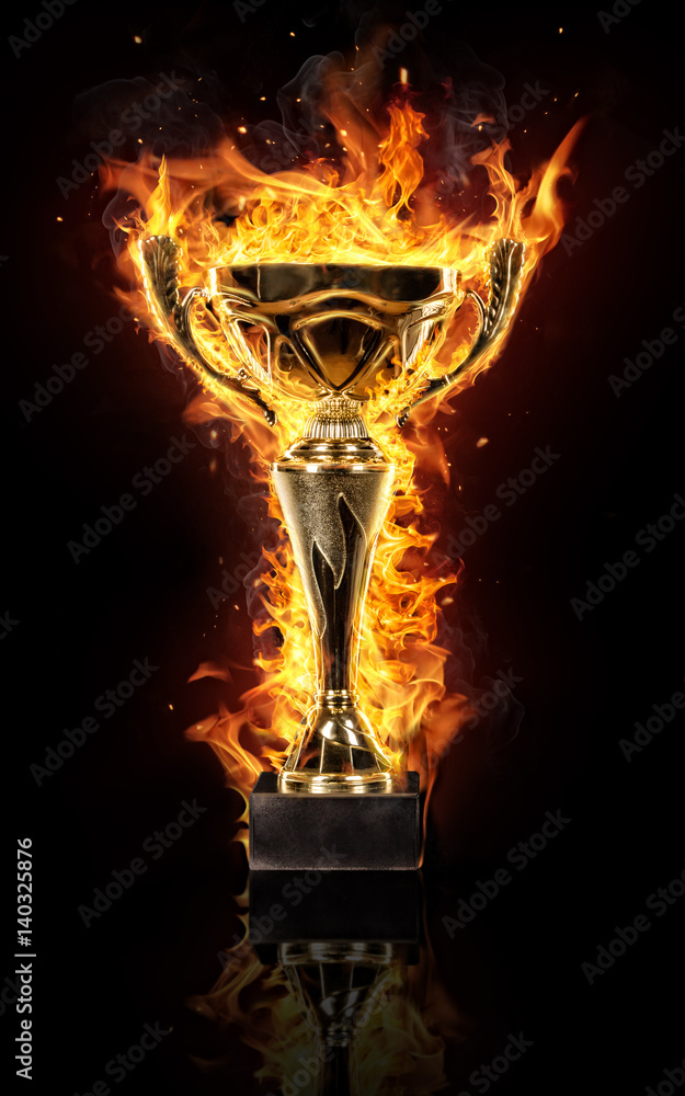 Burning gold trophy cup on black background Stock Photo | Adobe Stock