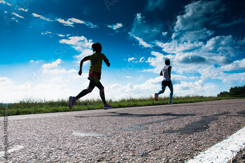 morning jog. the girl runs on the road.sport exchanges run on the road.the man runs on the road