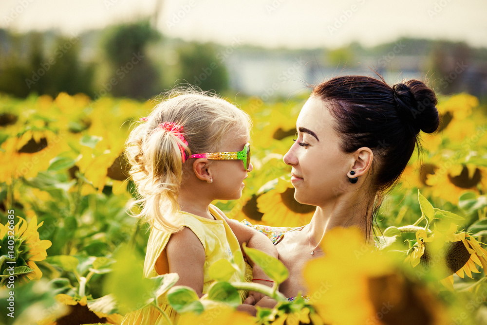 Mom and daughter in the field of sunflowers Mom and daughter in the field of sunflowers