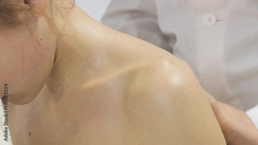 Masseur massaging the neck and shoulders of a girl Masseur massaging the neck and shoulders of a girl