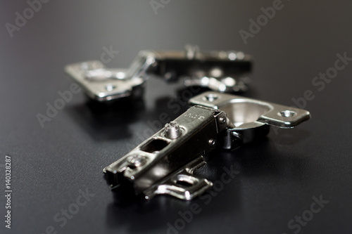 Schilderij op canvas Door Hinge isolated on black background