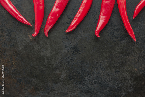 cayenne chilli peppers on rusty metal background. copy space