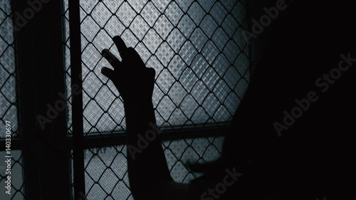 Helpless girl seeking exit or help. Silhouette children hands. child abuse, Refugees or abandoned child. Mental Institution. Family violence. 