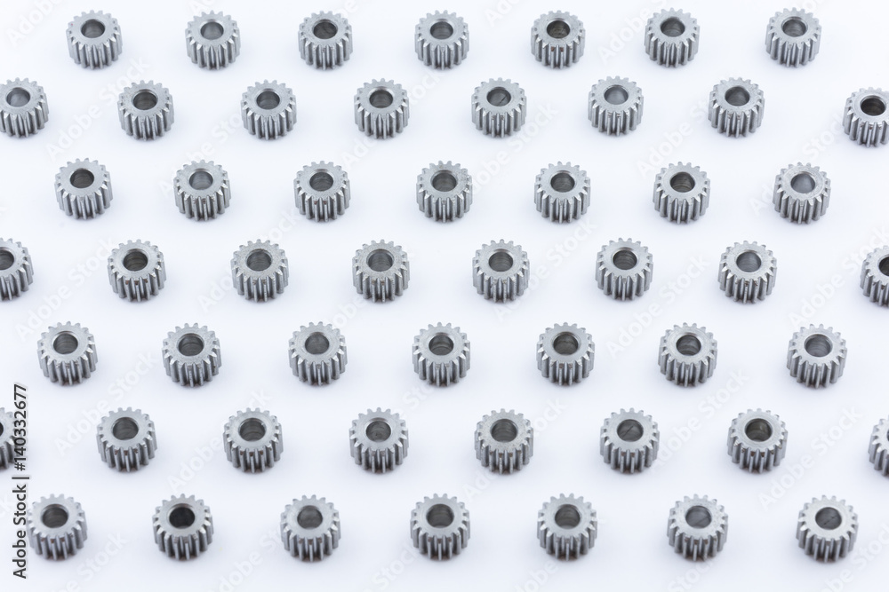 Isolated metal pinions gear. The iron gear on a white background. Pinions in the gearbox. Parts to the gear mechanism. Sprockets to clockwork. Shiny gear ready for assembly. Isolated metal pinions gear. The iron gear on a white background. Pinions in the gearbox. Parts to the gear mechanism. Sprockets to clockwork. Shiny gear ready for assembly.