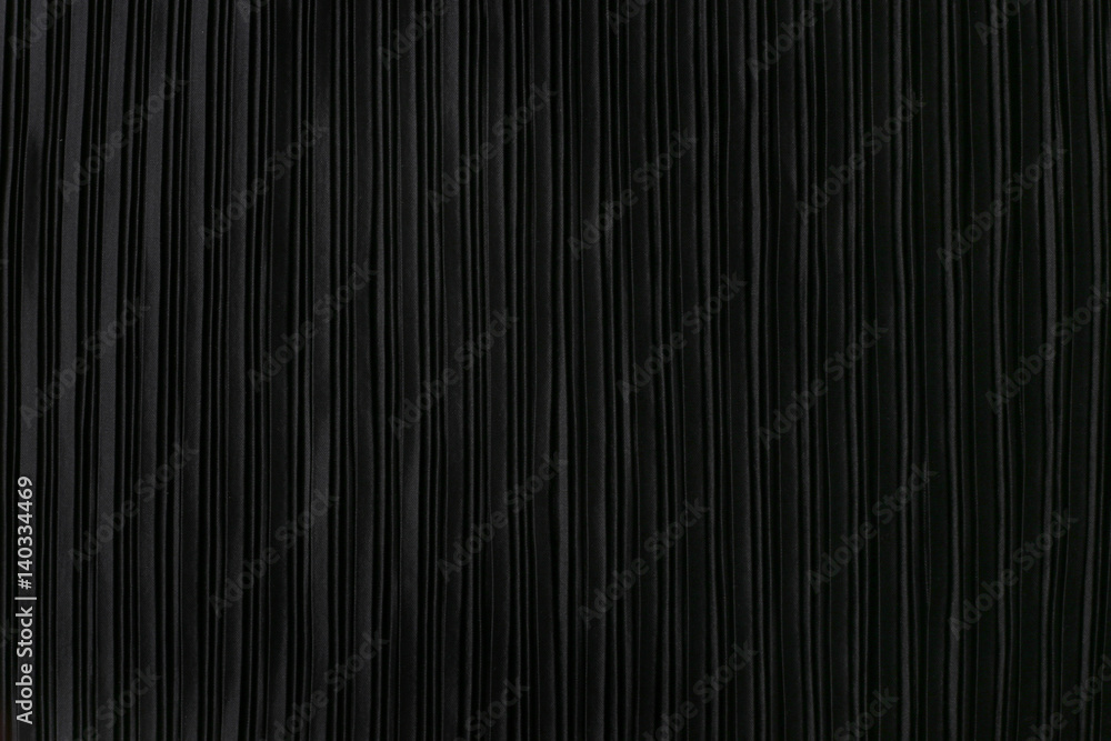 Obraz premium Black pleated fabric. Plisse fabric background texture.