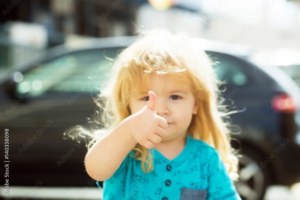 Cute baby boy gives thumbs up hand gesture Cute baby boy gives thumbs up hand gesture