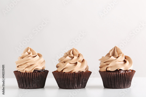 Tasty cupcakes on a white background