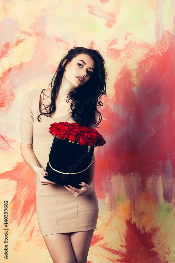 Pretty girl poses with red roses in box Pretty girl poses with red roses in box
