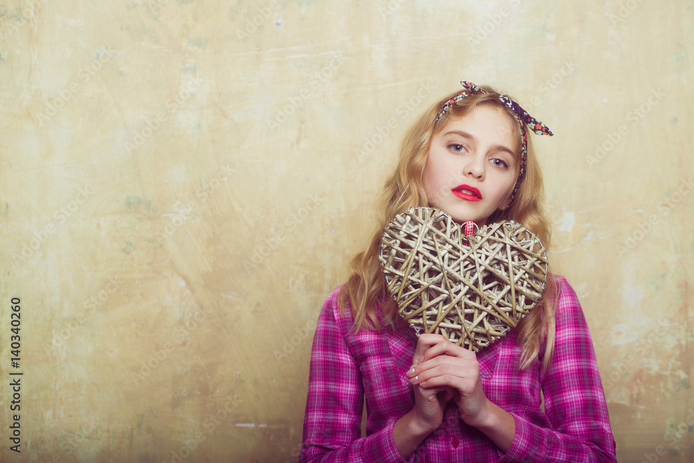Pretty girl with wicker heart for valentines day Pretty girl with wicker heart for valentines day