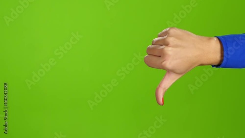 Female hand, sign language. Thumb up and then thumb down