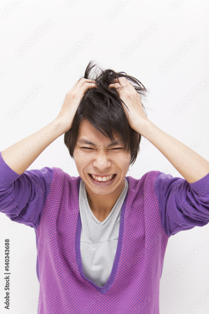 Young man with head in hands