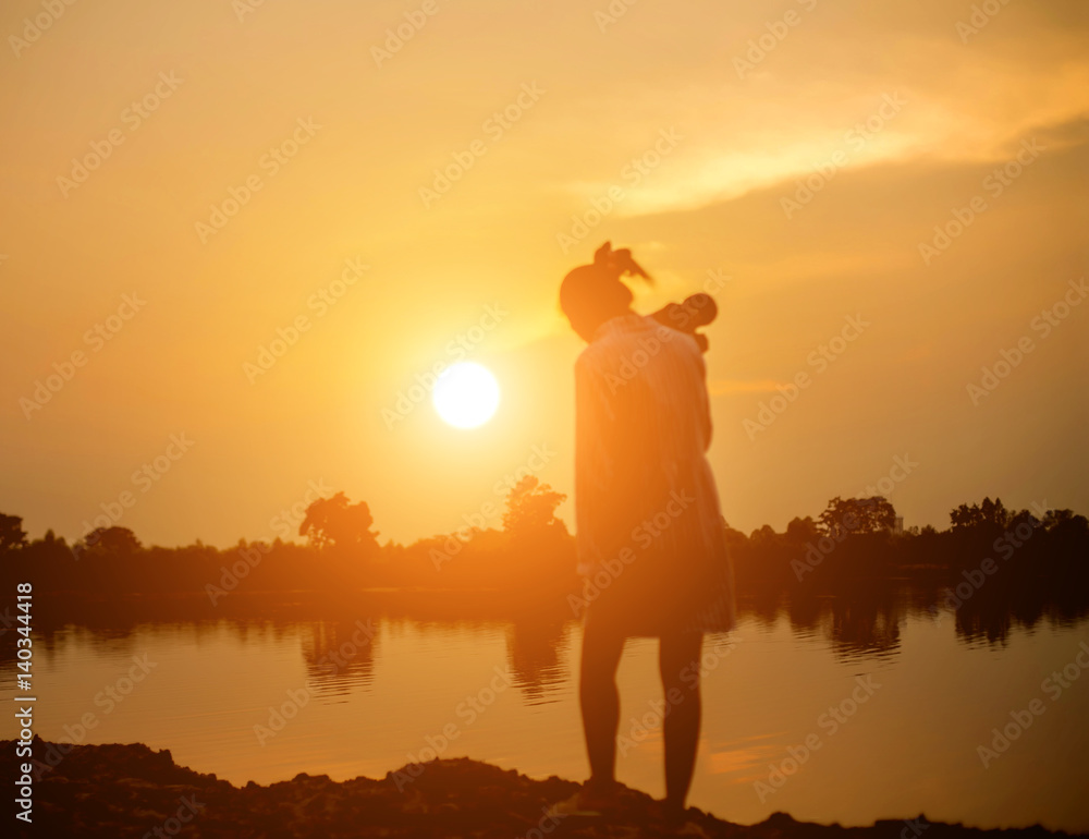 Woman holding a camera in  sunsets 