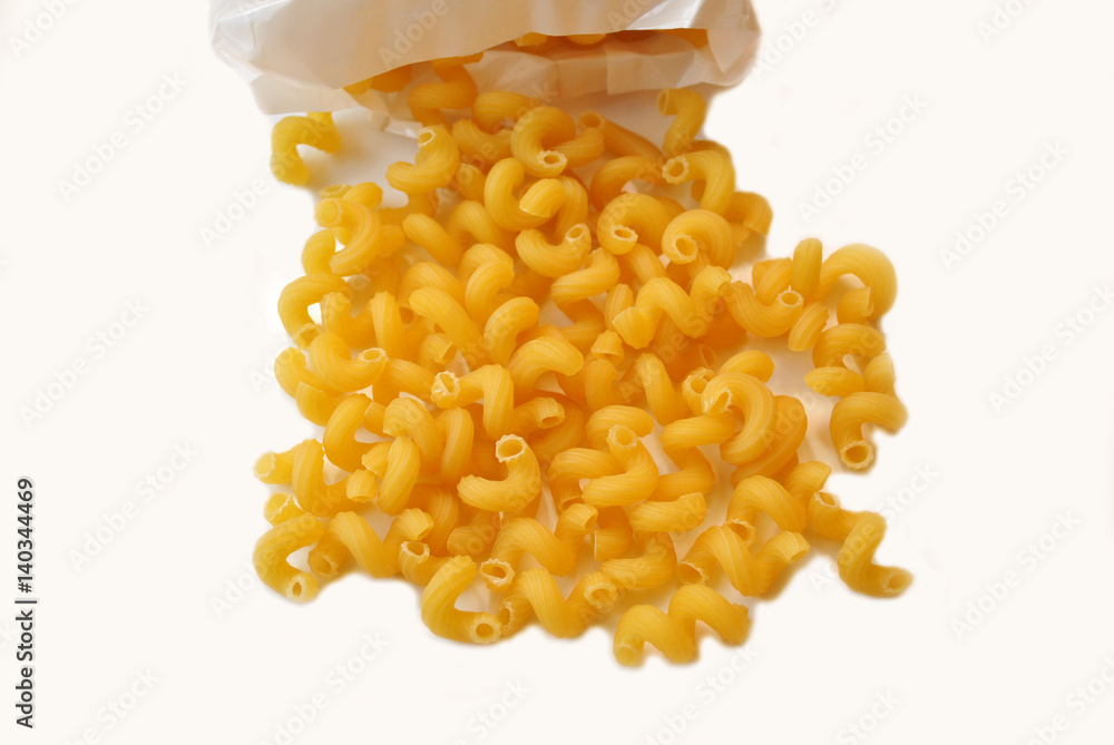 Cavatappi Spilling From a Package Over White Cavatappi Spilling From a Package Over White