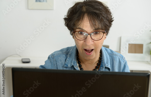 Photography woman with eyeglasses websurfing on laptop