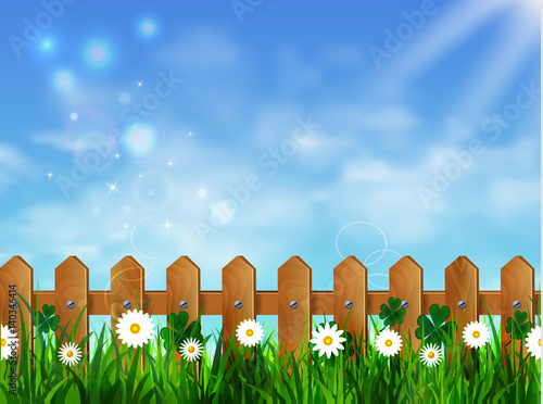 Green grass lawn with sunrise on blue sky