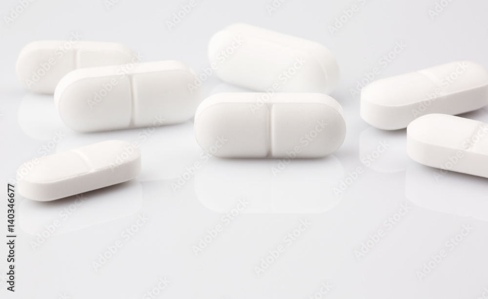 Pharmacy theme. White medicine tablets, antibiotic pills Pharmacy theme. White medicine tablets, antibiotic pills