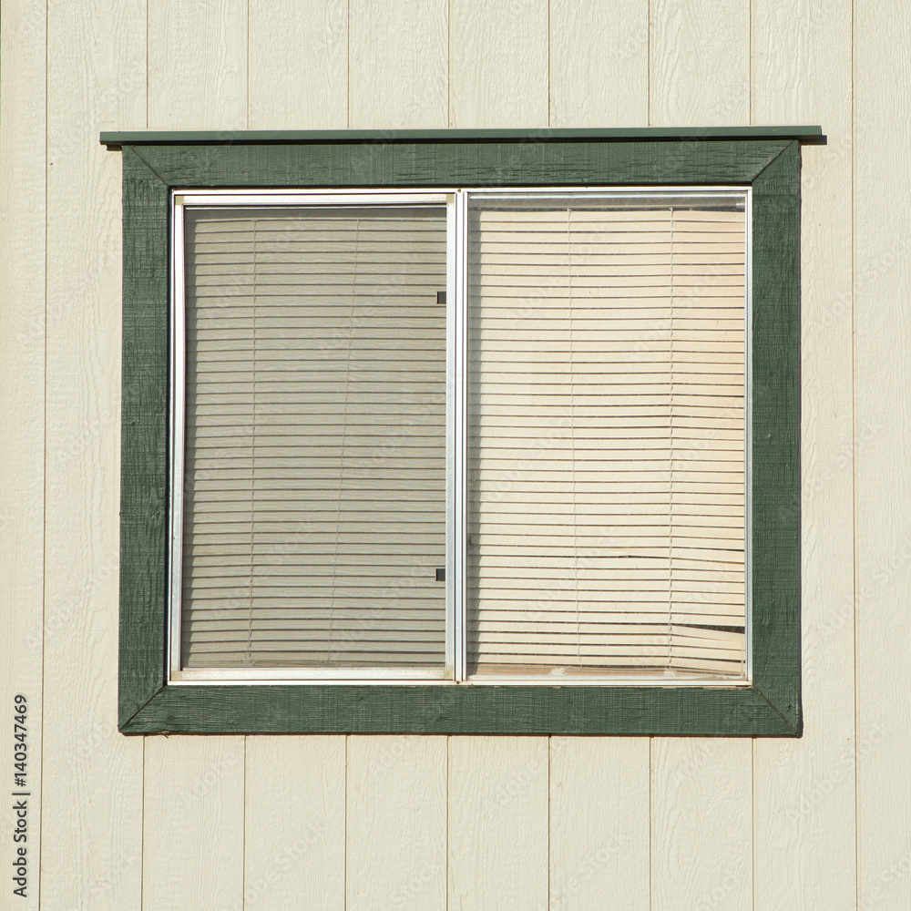 Fototapeta premium old window with plastic window blinds with wood walls.