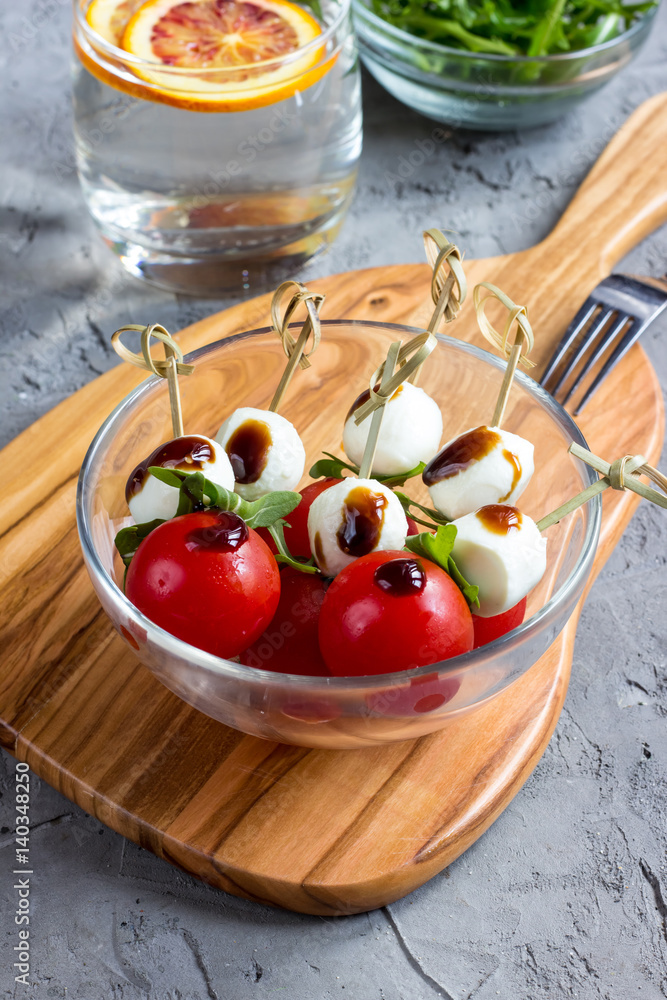 Skewers with tomatoes, arugula, mozzarella Skewers with tomatoes, arugula, mozzarella