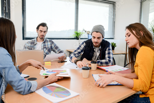 group of young cool hipster business people in casual wear working together in meeting room of a startup company