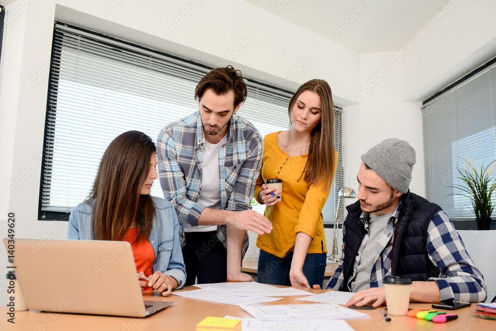 Fototapeta premium group of young cool hipster business people in casual wear working together in meeting room of a startup company