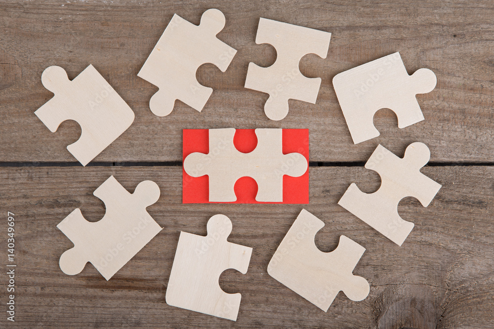 Fototapeta premium Jigsaw Puzzle Pieces on wooden background