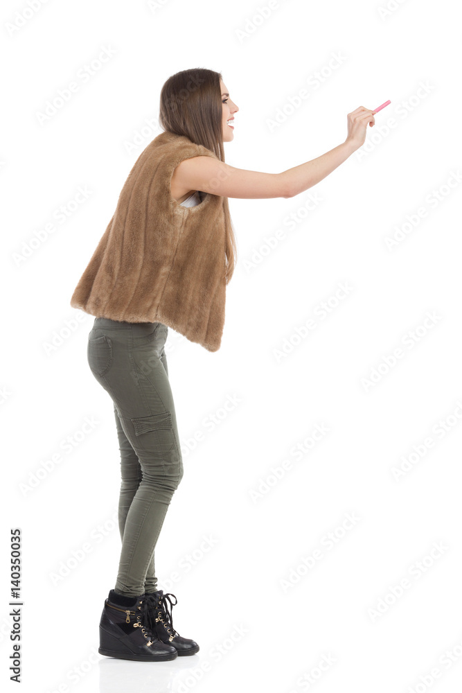 Woman In Brown Fur Waistcoat Writing, Side View Woman In Brown Fur Waistcoat Writing, Side View