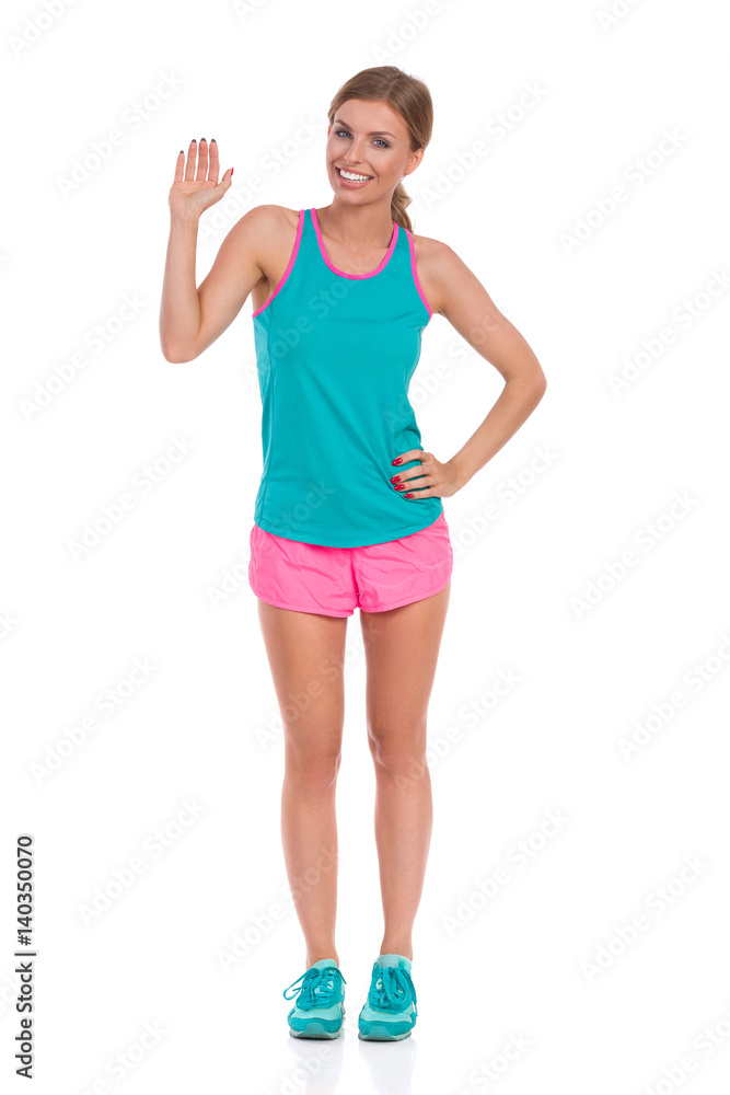 Smiling Woman In Vibrant Standing With Hand Raised Smiling Woman In Vibrant Standing With Hand Raised