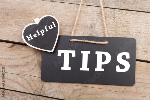 Blackboards with inscription "Helpful TIPS" on wooden background