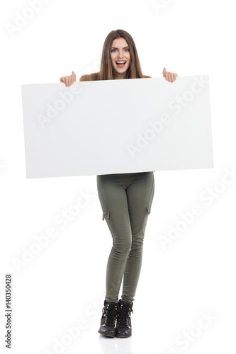 Smiling Woman Holds White Poster