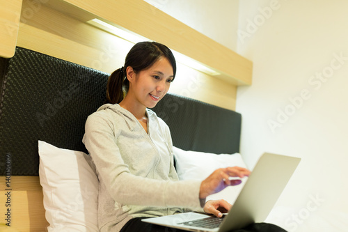 Woman using notebook computer at home