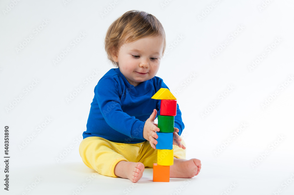 Little child playing with dices isolated on white background Little child playing with dices isolated on white background