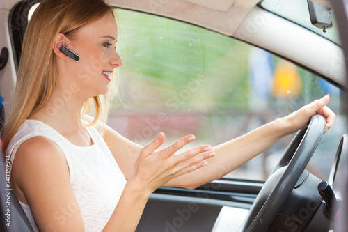 woman driving car with headset