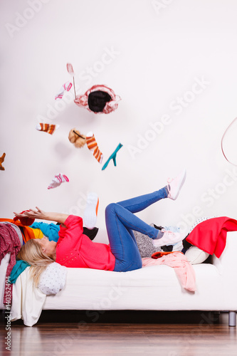 Woman lying on sofa, pelted clothes