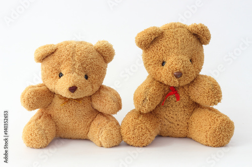 Two brown teddy bear on a white background. © Vichit