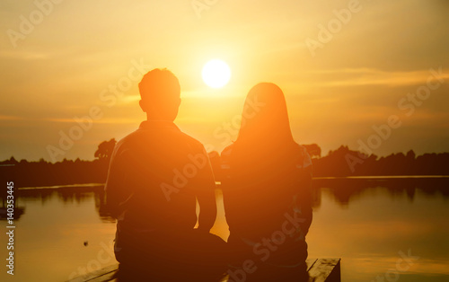 A man woman watching a sunset