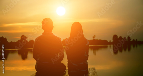 A man woman watching a sunset