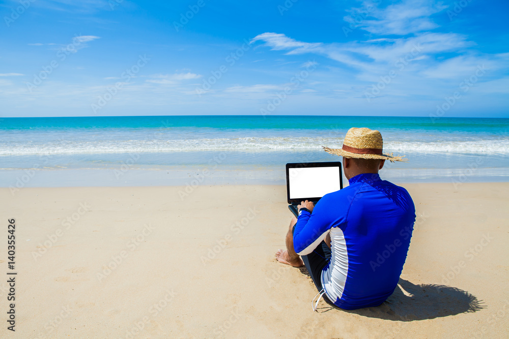 man with laptop on tropical beach vacation clipping path wiht white screen