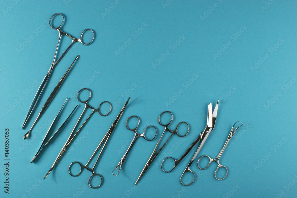 Surgical Instruments on blue background. Place for your text. Surgical Instruments on blue background. Place for your text.