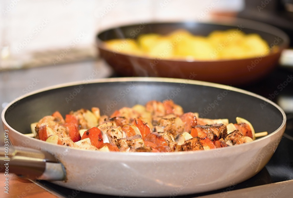 Chicken skewer with vegetables. Frying in a pan. Chicken skewer with vegetables. Frying in a pan.