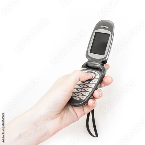 Girl is holding in hand retro flip flop mobile phone