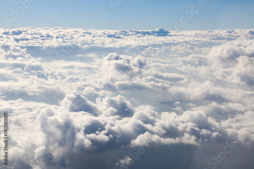View above the clouds from the window of an airplane