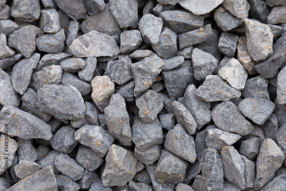 close up of gray crushed rock, stone raw material for construction industry. background and texture. close up of gray crushed rock, stone raw material for construction industry. background and texture.