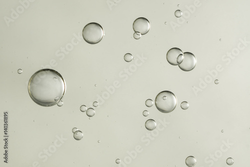 Light grey fizz bubbles over a blurred background