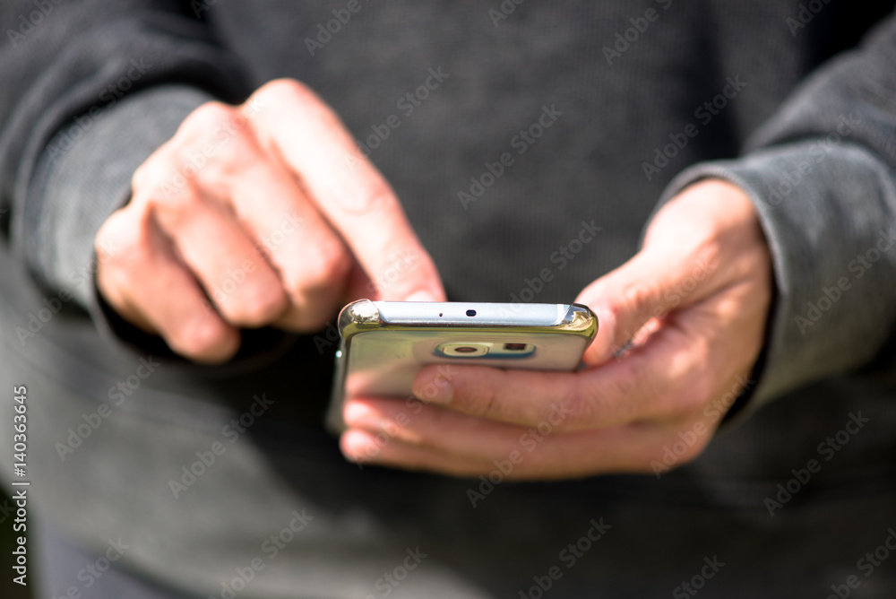 Fototapeta premium Man with mobile phone, touching the screen