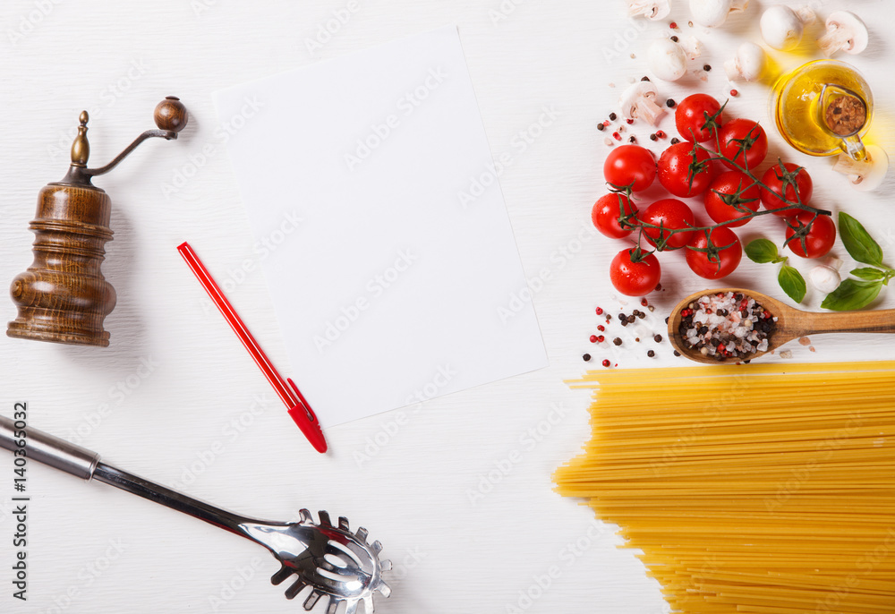 Pasta Spaghetti with ingredients for cooking pasta on a white background, top view. Copy space for Text. selective focus. Pasta Spaghetti with ingredients for cooking pasta on a white background, top view. Copy space for Text. selective focus.