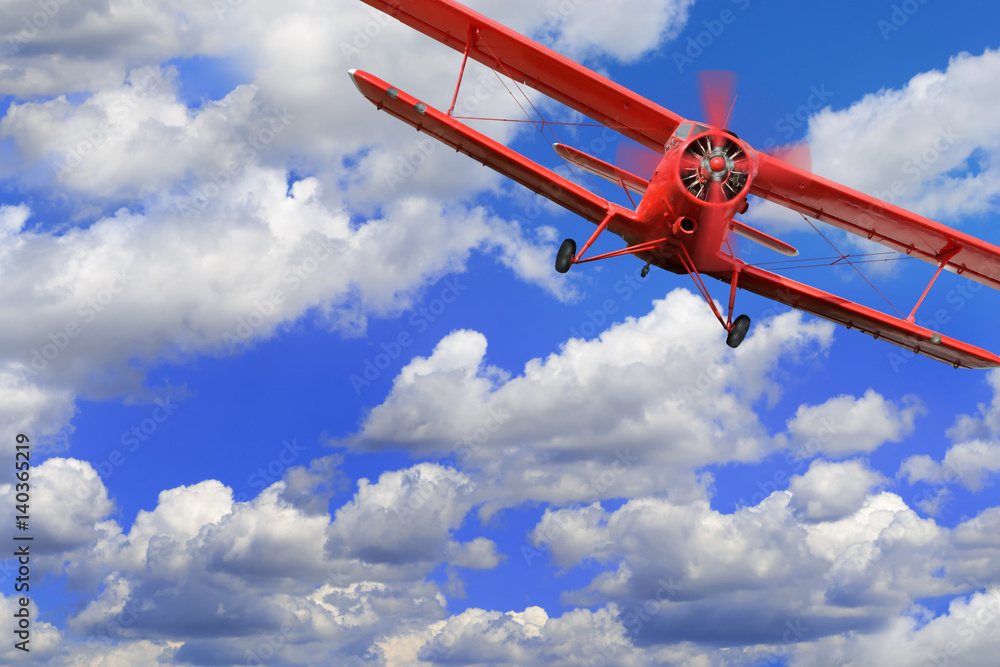 Obraz premium Red airplane biplane with piston engine