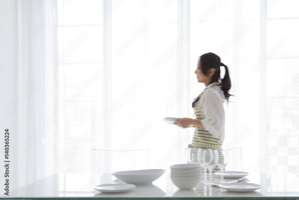 A woman setting a table A woman setting a table