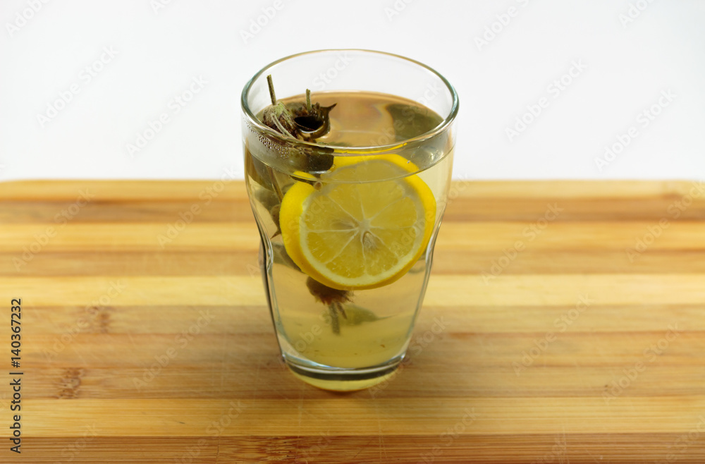 A hot glass of sage tea, with a lemon slice A hot glass of sage tea, with a lemon slice