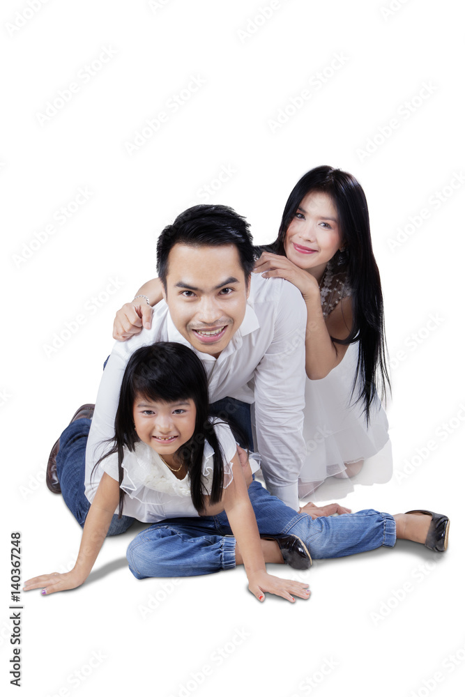 Girl and her parents smiling in studio Girl and her parents smiling in studio